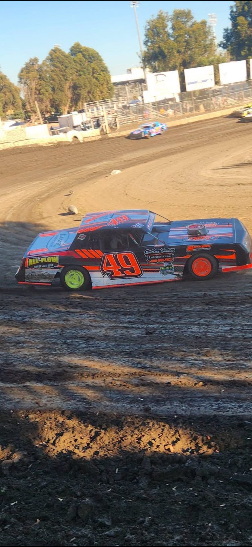 No. 49 car racing on the dirt with another competitor in the background