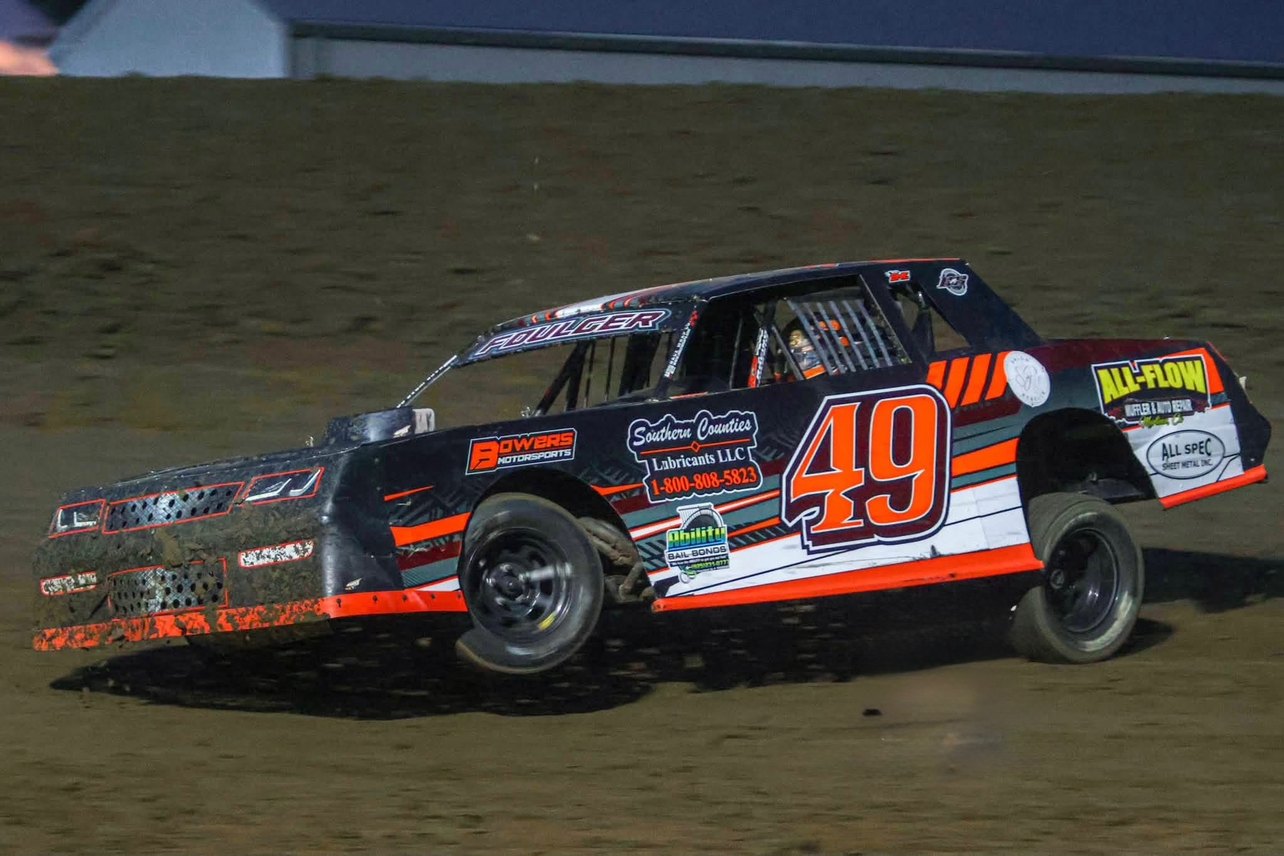 Troy Foulger's No. 49 car leaned hard through a muddy corner