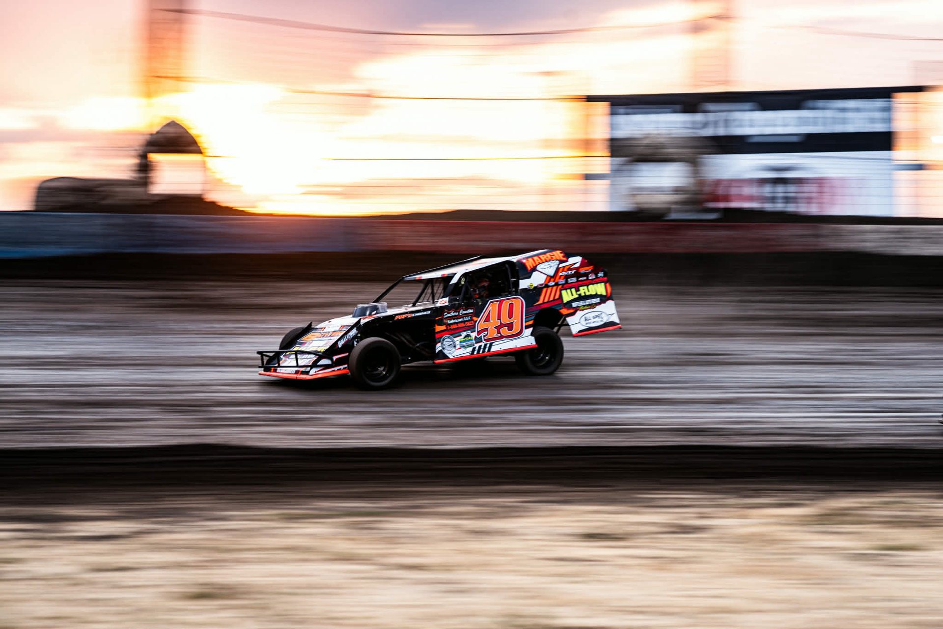 No. 49 car at speed at sunset, motion-blurred background